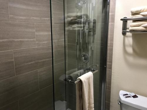 a shower with a glass door in a bathroom at Colton Inn in Colton