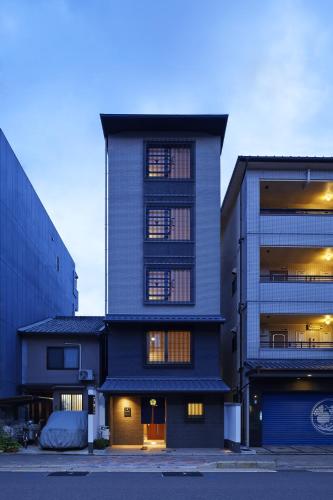 a tall building with windows in a city at Number 6 Nijo in Kyoto