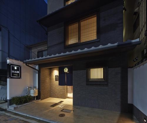 a building with a clock on the side of it at Number 6 Nijo in Kyoto