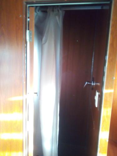 an open door with a curtain in a room at Onkel Inn Wagon Sleepbox Uyuni in Uyuni