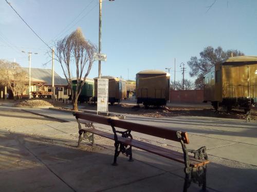 a bench sitting on the side of a street at Onkel Inn Wagon Sleepbox Uyuni in Uyuni