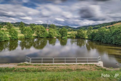 a river with a metal fence in the middle at Ferienwohnung Mörlenbach in Mörlenbach