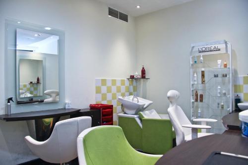 a restaurant with a table and chairs and a mirror at Ramee Rose Hotel in Dubai