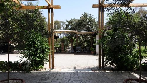 a wooden pergola with a table and chairs at Casa Vacanze Feudi 1165 in Borgo Vodice