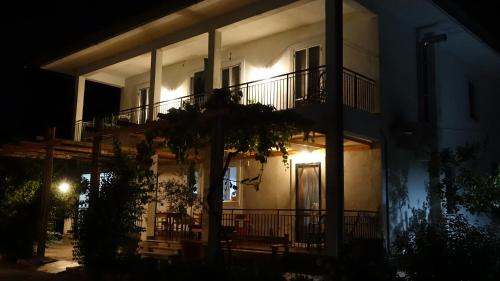 a white house with a balcony at night at Casa Vacanze Feudi 1165 in Borgo Vodice
