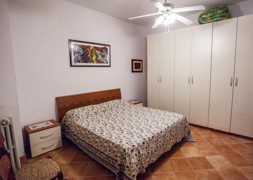 a bedroom with a bed and a ceiling fan at Erasippe Residence in Locri