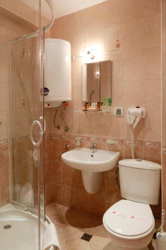 a bathroom with a toilet and a sink and a shower at Saint Stefan Villas in Sozopol