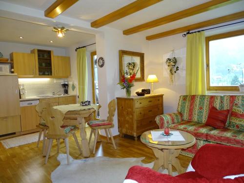 a living room with a couch and a table at Landhaus Feller in Reith bei Kitzbühel