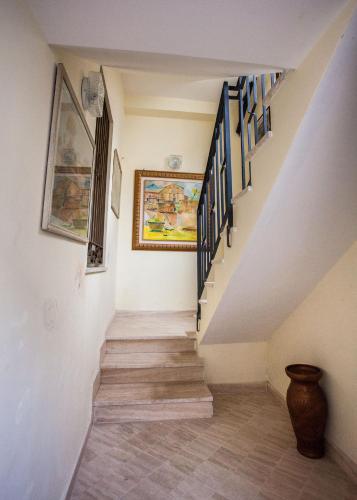 a staircase in a house with a painting on the wall at Erasippe Residence in Locri