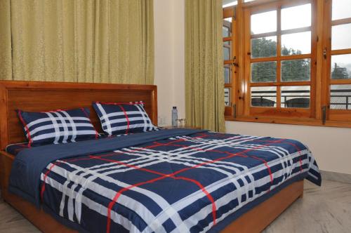 Postel nebo postele na pokoji v ubytování Vipul Home Stay