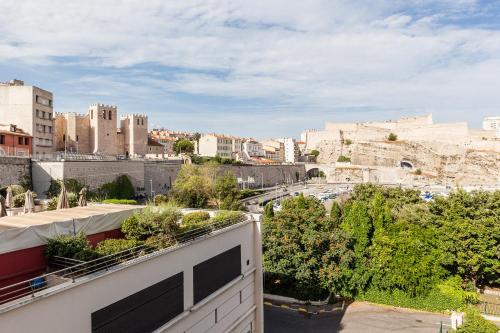 a view of the city from the roof of a building at Chez Nous - 7 Appartements sur le Vieux Port in Marseille
