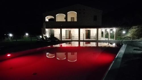a house with a swimming pool at night at B&B CasalFarano in Cupra Marittima