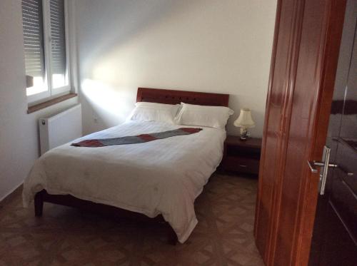 a bedroom with a bed and a window at Sanhe in Rollingen