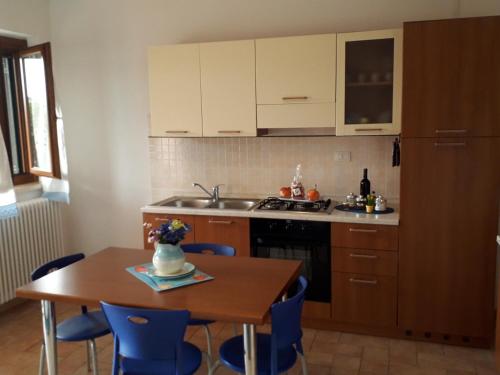 a kitchen with a table and a sink and a stove at Residence Ai Campi Da Golf Saturnia in Saturnia
