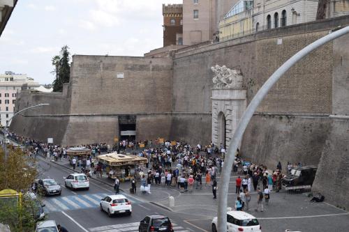 a crowd of people standing in front of a building at My Bed Vatican Museum in Rome