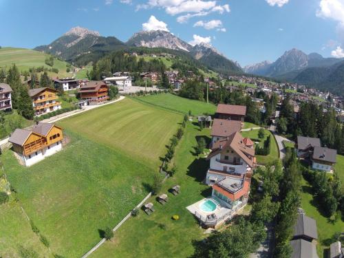 an aerial view of a house in a field with mountains at Villa Ortensia in San Vigilio Di Marebbe
