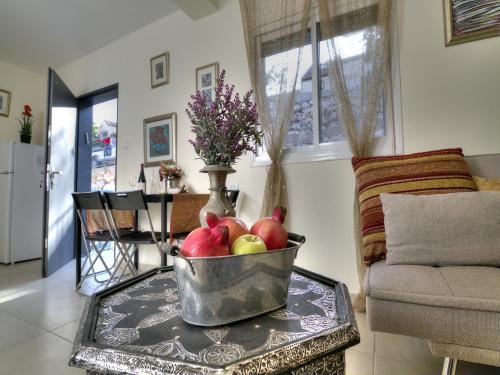 a bowl of apples on a table in a living room at Amazing Galilee View in Safed
