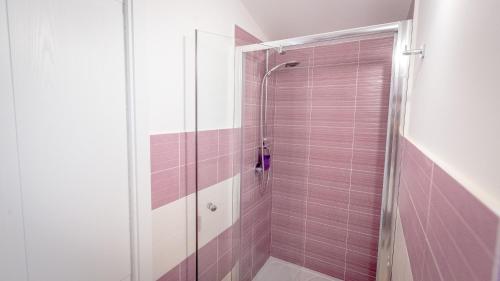 a bathroom with a shower with pink tile at Villa Patrizia Selinunte in Marinella di Selinunte