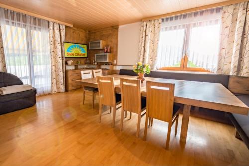 a living room with a dining room table and chairs at Sun Chalet in Schladming
