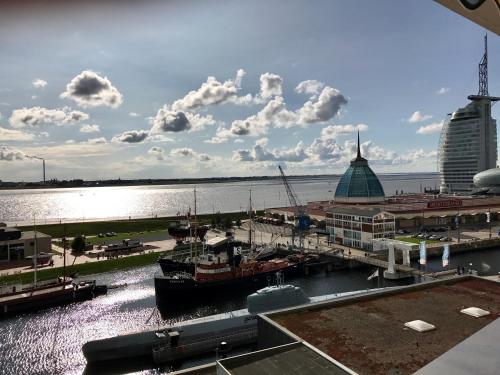 a boat is docked at a marina on the water at Coast House Moana in Bremerhaven