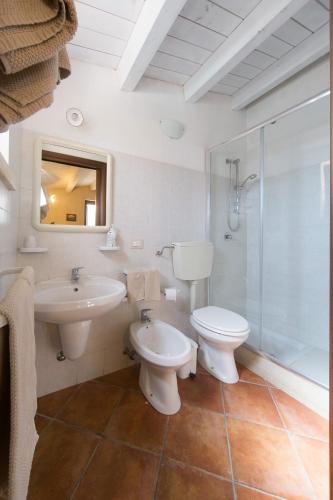 a bathroom with a toilet and a sink and a shower at Casale del Coccio in Scicli