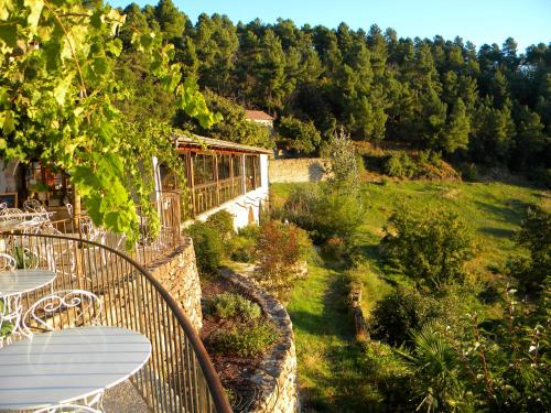 a view of a garden with tables and chairs at Auberge de la Tour de Brison in Sanilhac