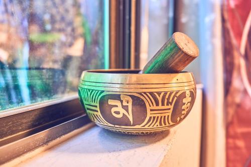 a bowl with a wooden spoon sitting on a window sill at Harmony House Homestay in Sedona