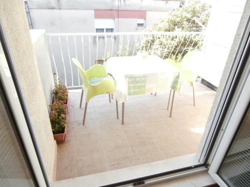 a patio with a table and chairs on a balcony at Apartment studio Mia-beach in Split in Split