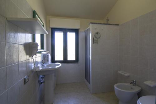 uma casa de banho com um lavatório e um WC em Agriturismo Sa Rocca em Iglesias