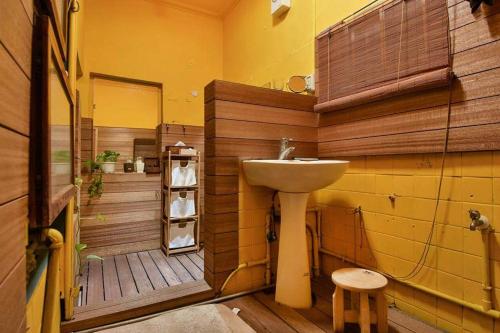 a bathroom with a sink and a bath tub at Green House in Tainan
