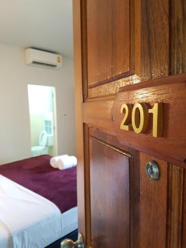 a room with a door with the number on it at The Sandy House Khaolak in Khao Lak