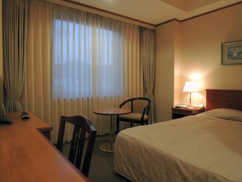 Ένα ή περισσότερα κρεβάτια σε δωμάτιο στο Hotel Crown Palais Kokura