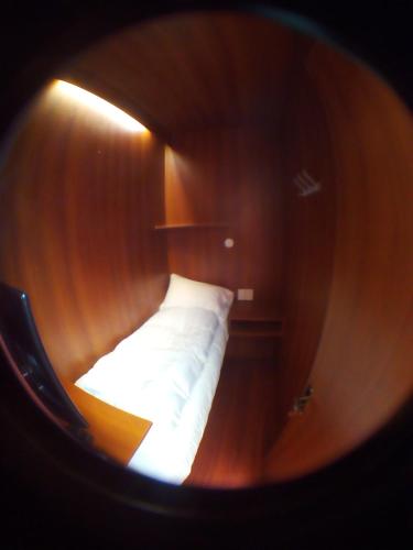 a view of a bed in a wooden room at Onkel Inn Wagon Sleepbox Uyuni in Uyuni