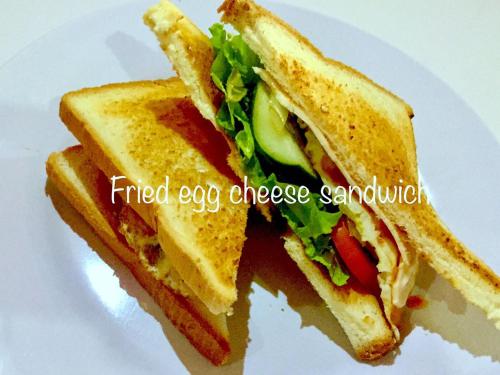 a sandwich cut in half on a white plate at Gubug Balian Beach Bungalow in Selemadeg