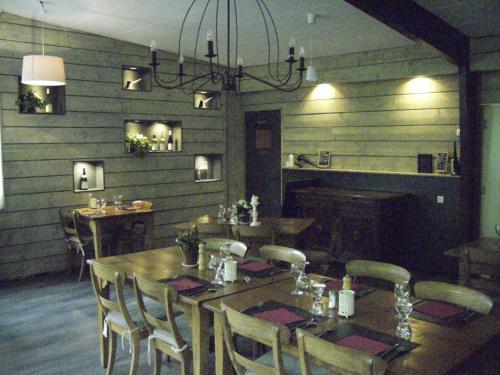 a dining room with a wooden table and chairs at Chalet du Montal in Dun-les-Places