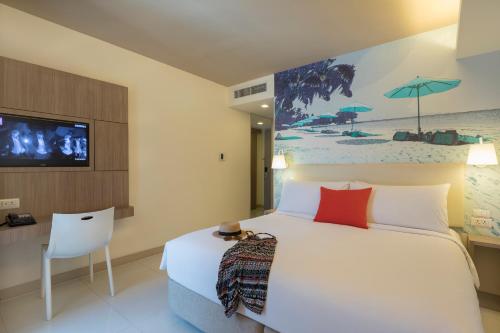 Travelodge Pattaya tesisinde bir odada yatak veya yataklar
