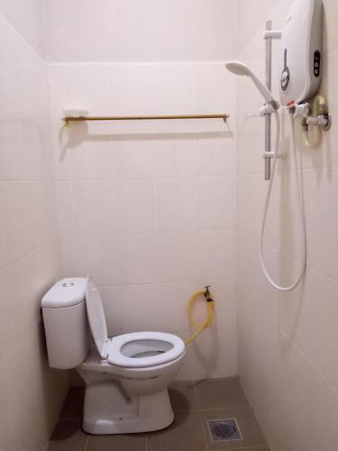 a bathroom with a toilet and a shower at Nas Villaria Langkawi in Pantai Cenang
