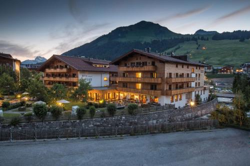 a hotel with a mountain in the background at Hotel Gotthard in Lech am Arlberg