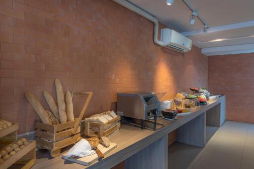 a room with a counter with food and a brick wall at Travelodge Pattaya in Pattaya Central