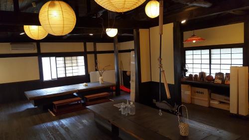 a dining room with a table and some lights at Tawaraya Ryokan Koto Shirasagikan in Usuki