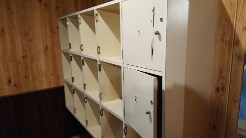 a row of white lockers in a room at Tawaraya Ryokan Koto Shirasagikan in Usuki