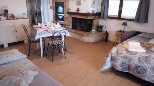 a living room with a table and a fireplace at B & B LE TRE B in Fano