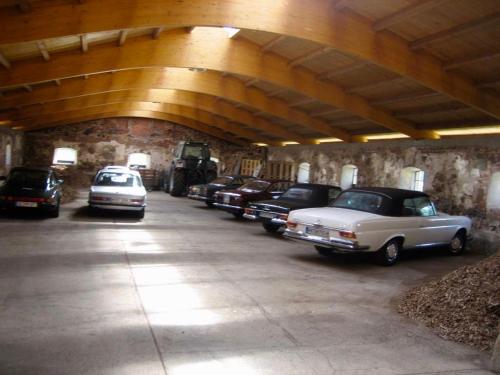 a row of old cars parked in a garage at Jagdschloss Kotelow in Kotelow