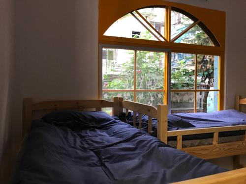 Postel nebo postele na pokoji v ubytování No. 6 Cuobian Hostel