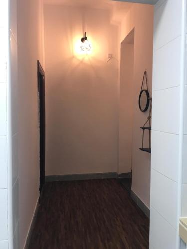 an empty hallway with a light on the wall at No. 6 Cuobian Hostel in Shantou
