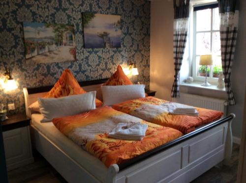 a bedroom with a large bed with two towels on it at Pension Schmitz in Serrig