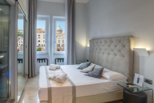 a bedroom with a large bed with a large window at Pantheon Caesar Relais in Rome