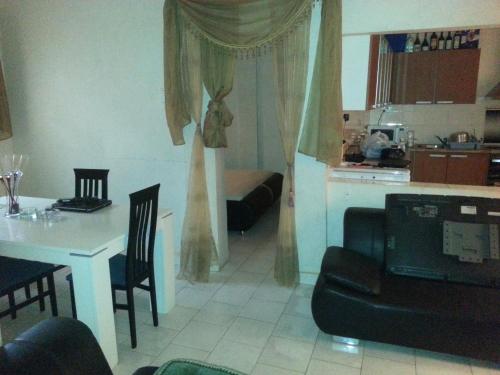 a living room with a table and a dining room at Woodpecker Resort Hotel in Bathurst