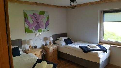 a bedroom with two beds and a window at Apartments Grillstube in Neustift im Stubaital