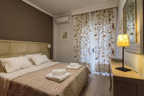a bedroom with a bed with towels on it at Luxury Apartment Philoxenia in Thessaloniki